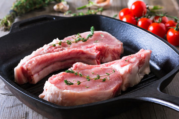 Raw steaks in grill pan ready to cook