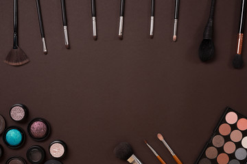 brush for makeup, eye shadow, view from above. On a brown background