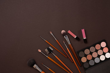 The women's cosmetics set on a brown background, modern woman.