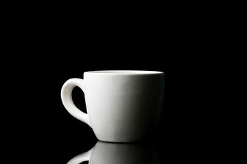 White cup on black background.