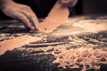 The chef makes fresh spaghetti from scratch.