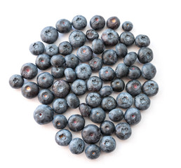 Natural looking blueberries on white background. Top view. Selective focus in the middle.