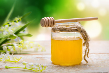 Honey in jar on wooden table