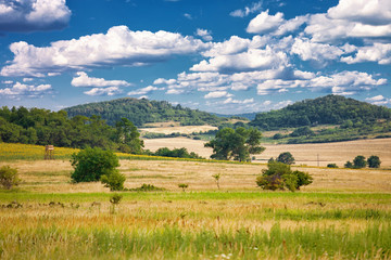Landscape of countryside with hills, meadows, hunter tower &eacute;s a nice cloudscape