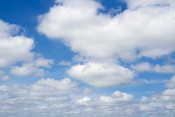 Fototapeta premium Blue sky with flying clouds over horizon. White clouds against blue sky.