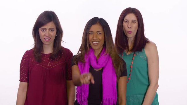 Three woman bully the viewer. Medium shot on white background.