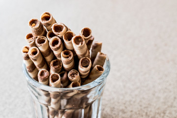 Wafer rolls in glass cup.