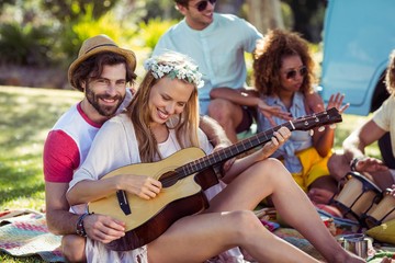 Group of friends having fun and playing music 