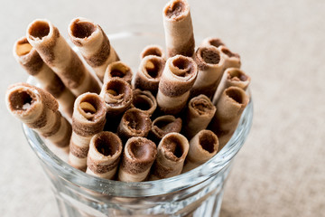 Wafer rolls in glass cup.