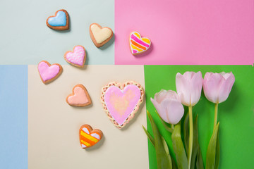 Colorful cookies in heart-shapes on a color background
