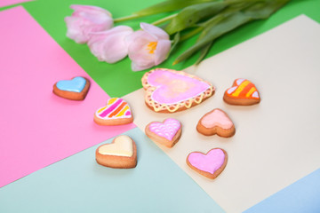 Colorful cookies in heart-shapes on a color background
