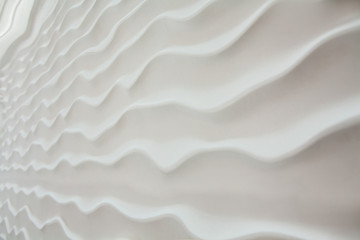 White seamless texture of wavy background. 3D wall panels decoration. White abstract waves. Close-up.
