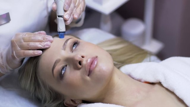 Woman having a water clean skin treatment in a skincare clinic