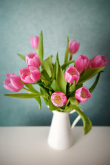 Bouquet of pink tulips in a white vase