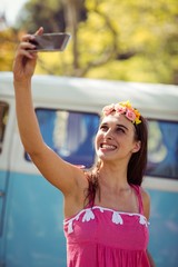 Smiling woman taking a selfie in park