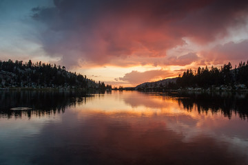 Colorful sunset reflection in a lake in the Sierra Nevada of California