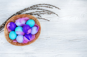 Basket with colored eggs on a white background. Concept Happy Easter.