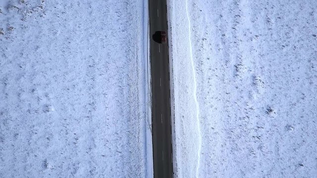 A road Intersecting a Barron Lave Field Covered in Snow