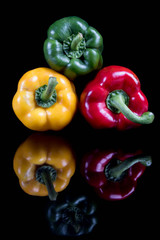 A stack of sweet bell peppers with reflections