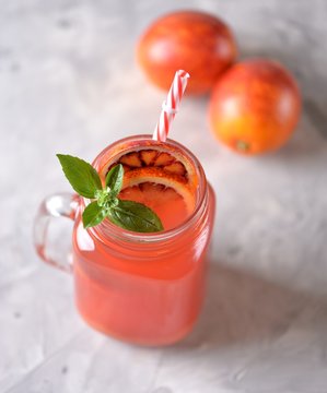 Delicious homemade lemonade made from red orange with ice. Healthy drink.