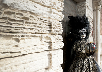 Carnival mask under the loggia of Ducale Palace in Venice, Italy.