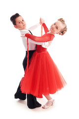 Lovely little boy and girl dancing. Isolated on white background