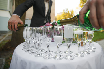 glasses with champagne. catering banquet table. a lot of snacks and canapes
