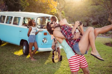 Man carrying a woman in park