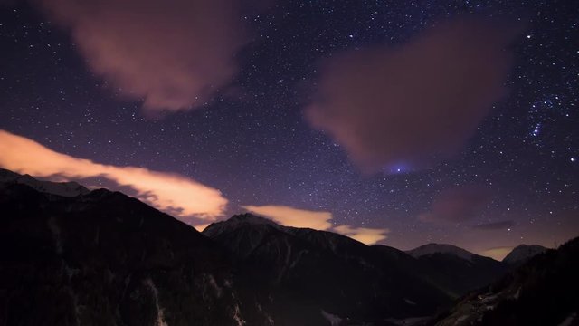 4K Time-lapse of a beautiful cloudy starry dark night with the Milky Way and Orion Constellation