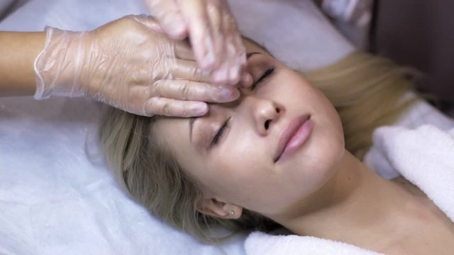 Attractive female at spa health Club getting a facial massage