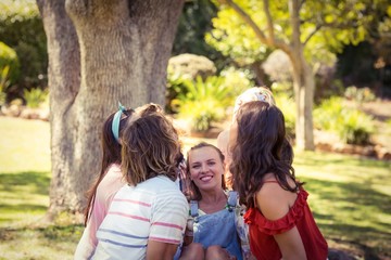 Fototapeta premium Group of friends lifting woman at campsite