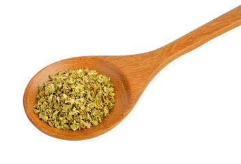 Dried oregano in wood spoon on white background