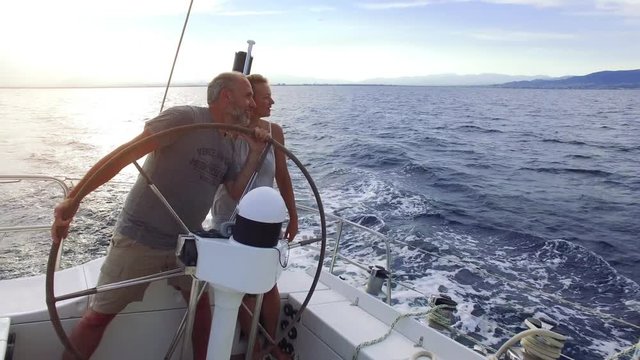 couple on sailboat sailing the ocean