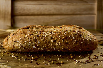 wholemeal bread roll topped with different seeds