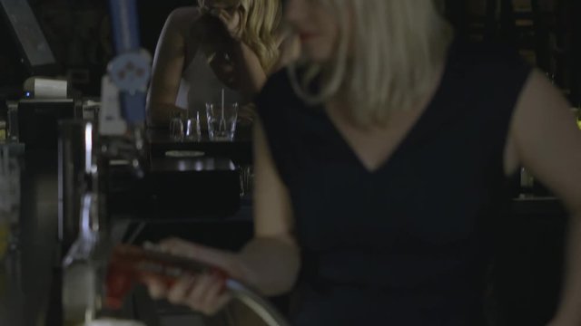 Female bartender pours drink and drugs it.