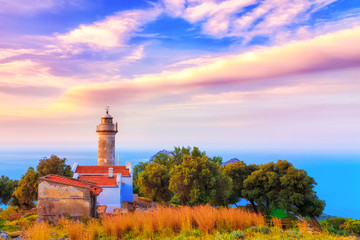 Fototapeta na wymiar Lighthouse at Gelidonia cape in Mediterranean sea. Turkey, Antalya, Karaoz. Beautiful sunset scenery with dramatic sky.
