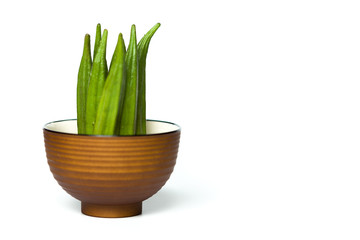 Okra in a bowl isolated over white background