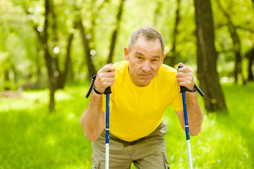 Tired elderly people engaged in Nordic walking