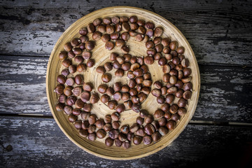 Hazelnuts on wood background
