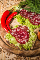 Sliced tasty Chorizo sausage over the wooden background