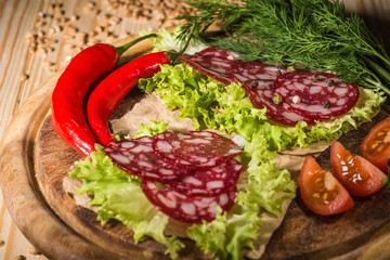 Sliced tasty Chorizo sausage over the wooden background