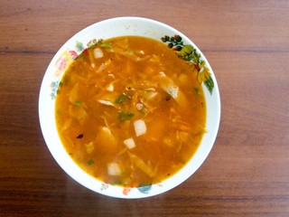 Red ukrainian soup (borsch) on wooden table