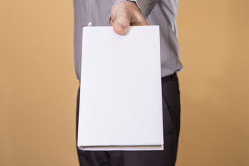 Man holding a blank book