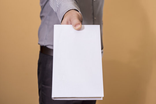 Man Holding A Blank Book