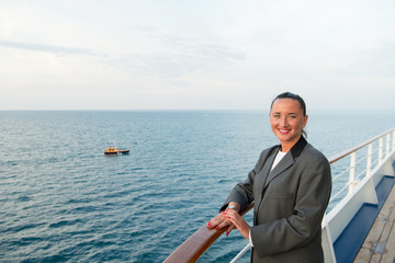 pretty business woman or happy cute girl on ship deck