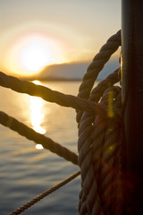 Detail of Ropes on Sailboat with Sunset in Background