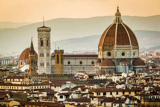 Florence, Tuscany, Italy. cityscape and Cathedral and Brunelleschi Dome, Giotto Tower. Sunset, lights on.