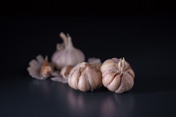 Garlic. Fresh Garlic. Cloves of garlic on black background.