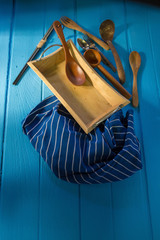 wood cookware over blue wooden table background.