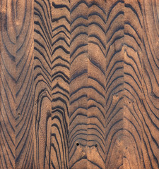 Treated wood background, striped wood texture, freshly-colored elm, paint brown stain